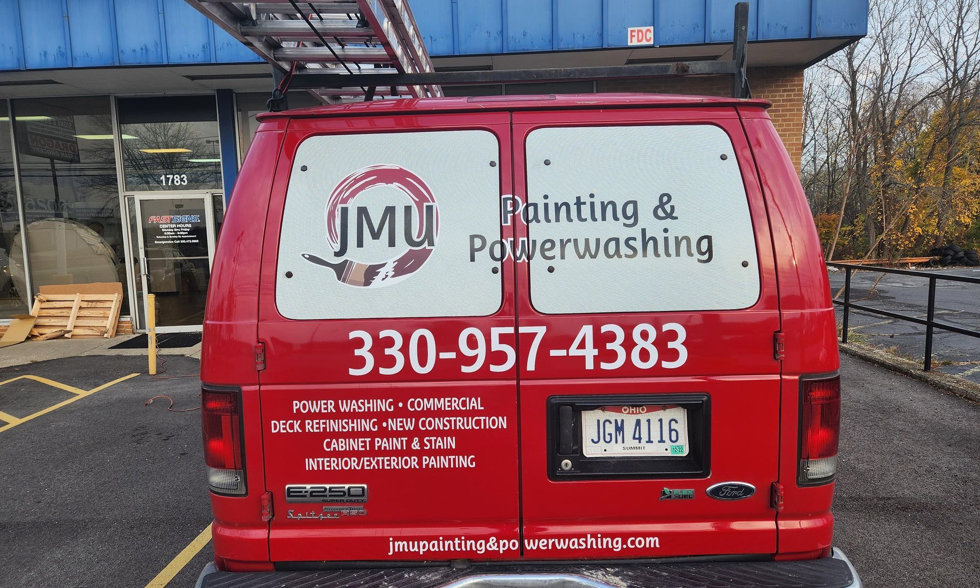 The branded JMU Painting & Power Washing work van