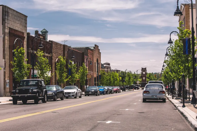 Brick storefronts, street trees and the clock tower along Front Street in downtown Cuyahoga Falls.
