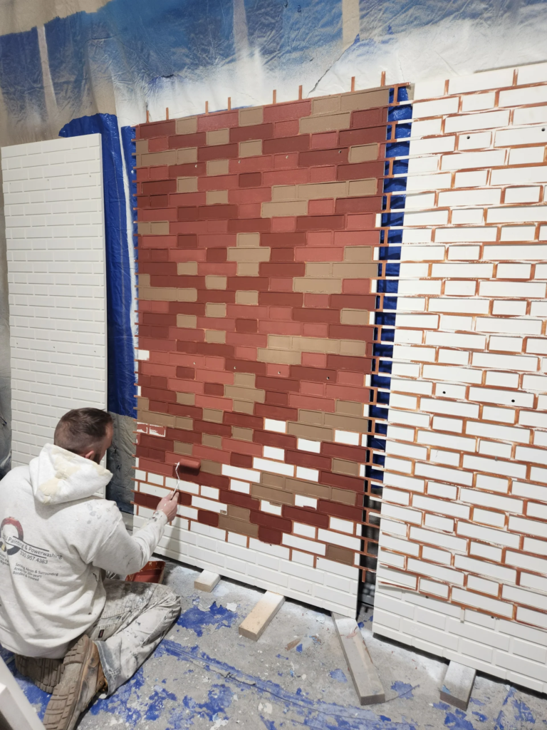 Clean painter's tape lines on a brick accent wall during prep