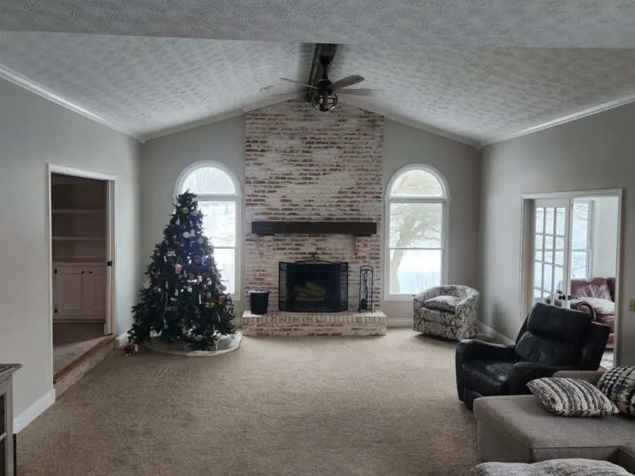 A living room with a fireplace and a christmas tree