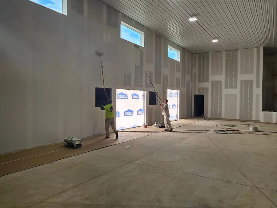 A large empty room with a ceiling that is being built.