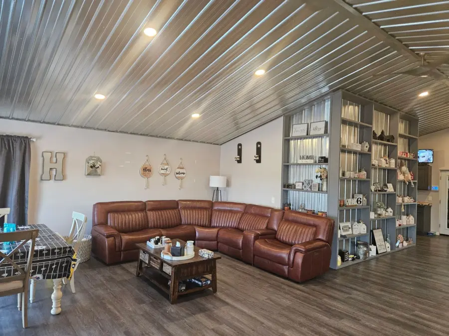 A living room with a large sectional couch and a coffee table.