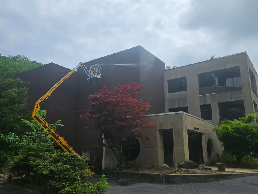 A large building with a crane on the side of it.