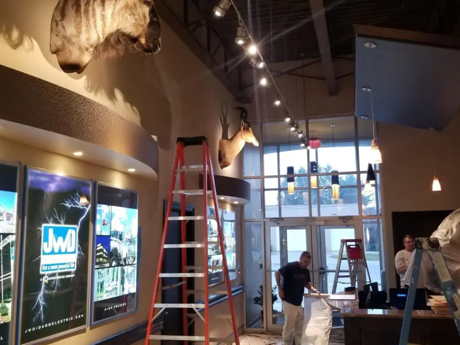 A room with a ladder and stuffed animals on the wall