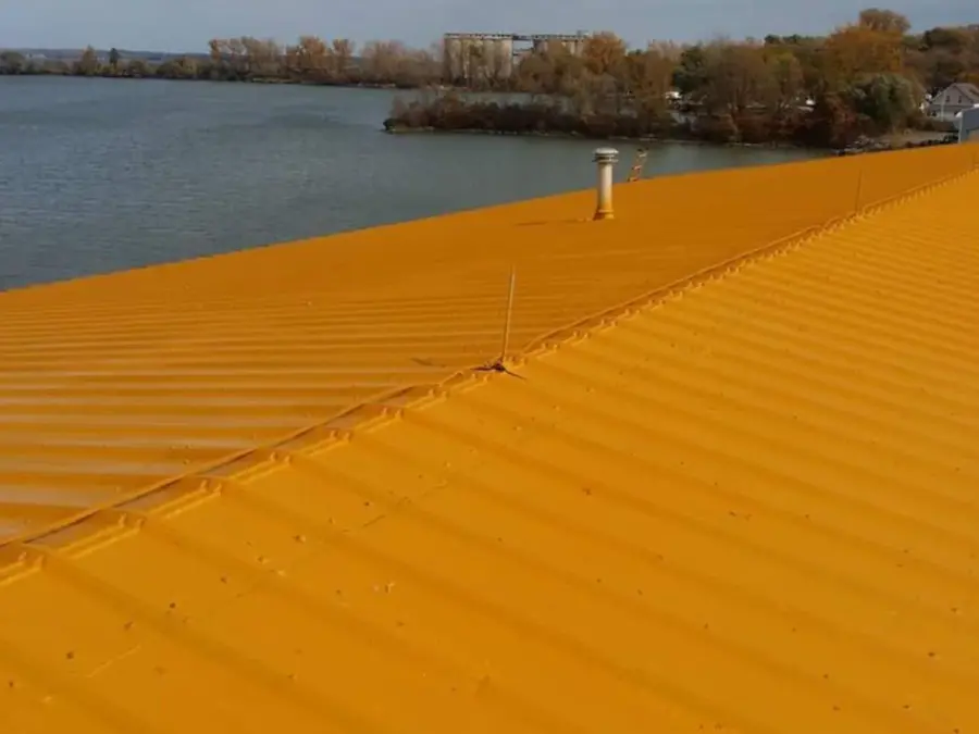 A yellow roof with a river in the background.