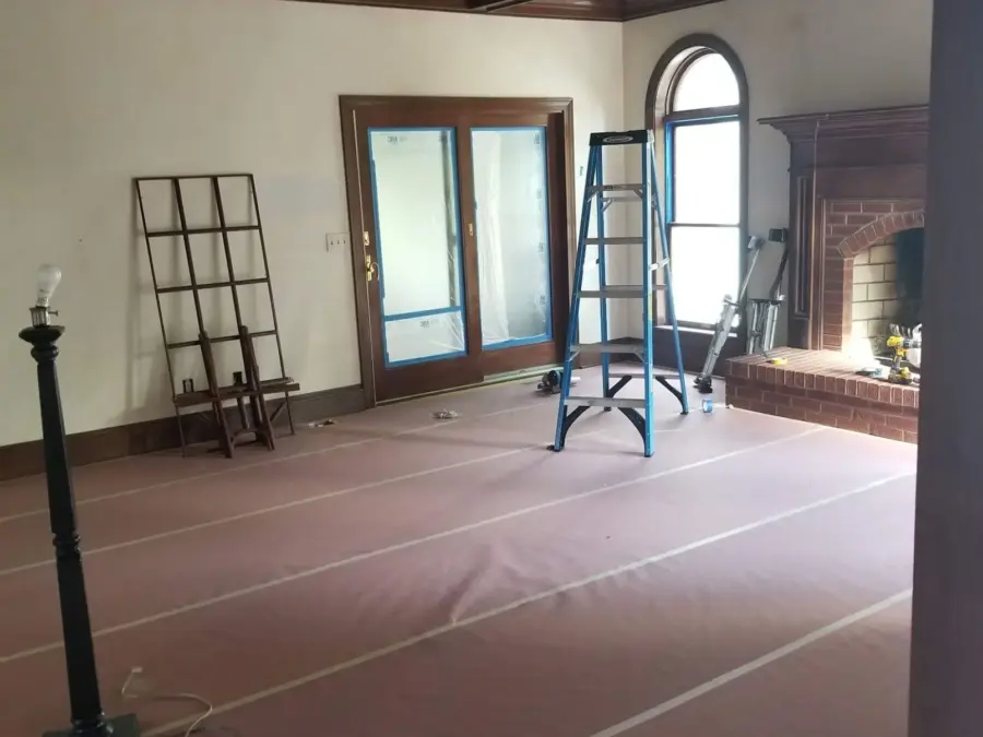An empty room with a ladder in the middle of it