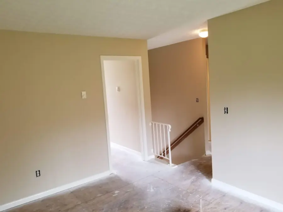 An empty room with a staircase leading to the second floor