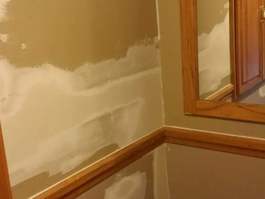 There is a mirror in the corner of the room.
