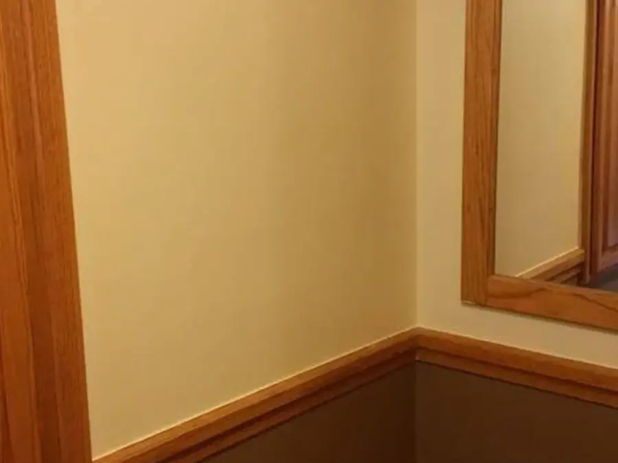 A room with a large mirror on the wall.